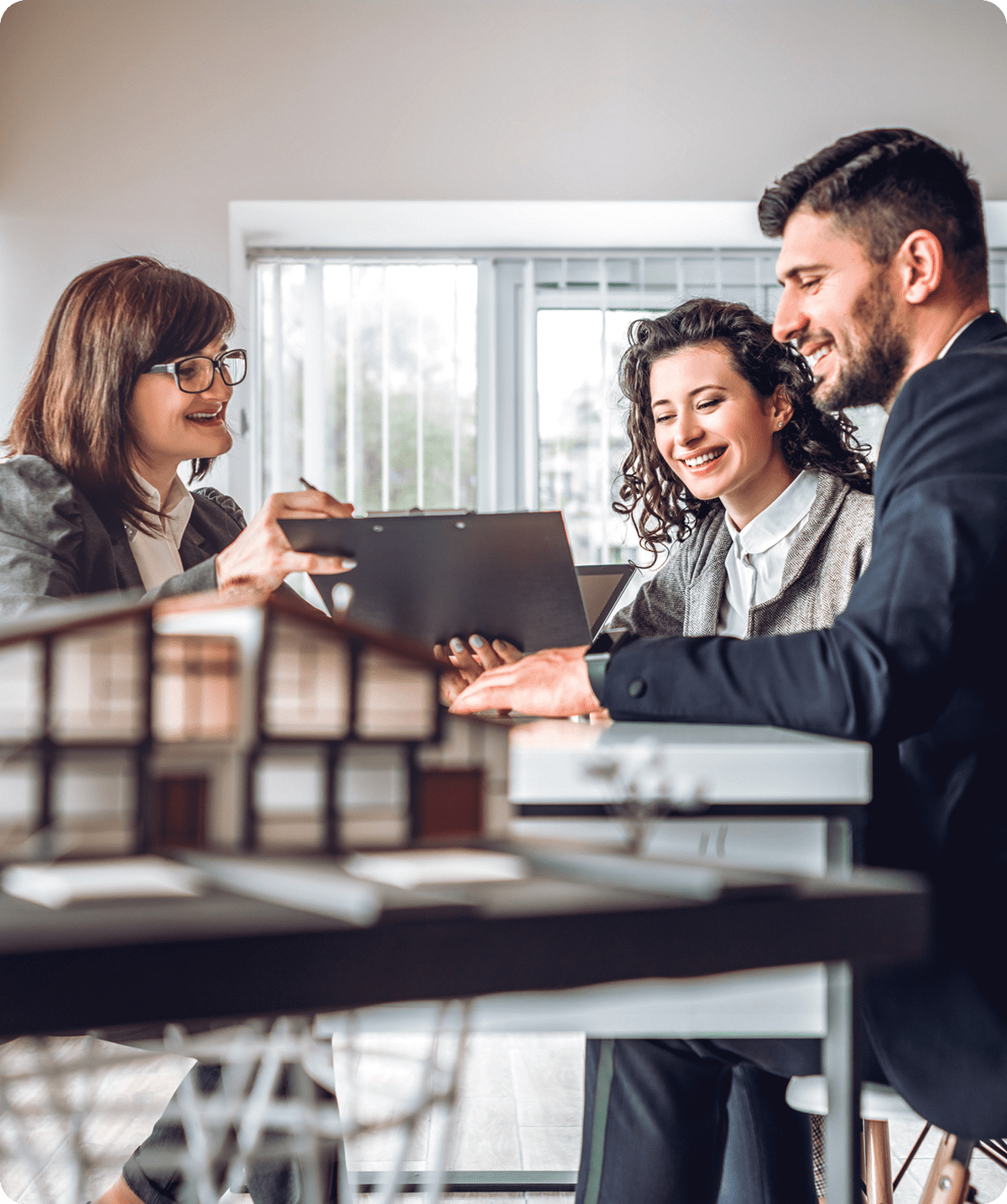 Real estate agent discussing with clients indoors.