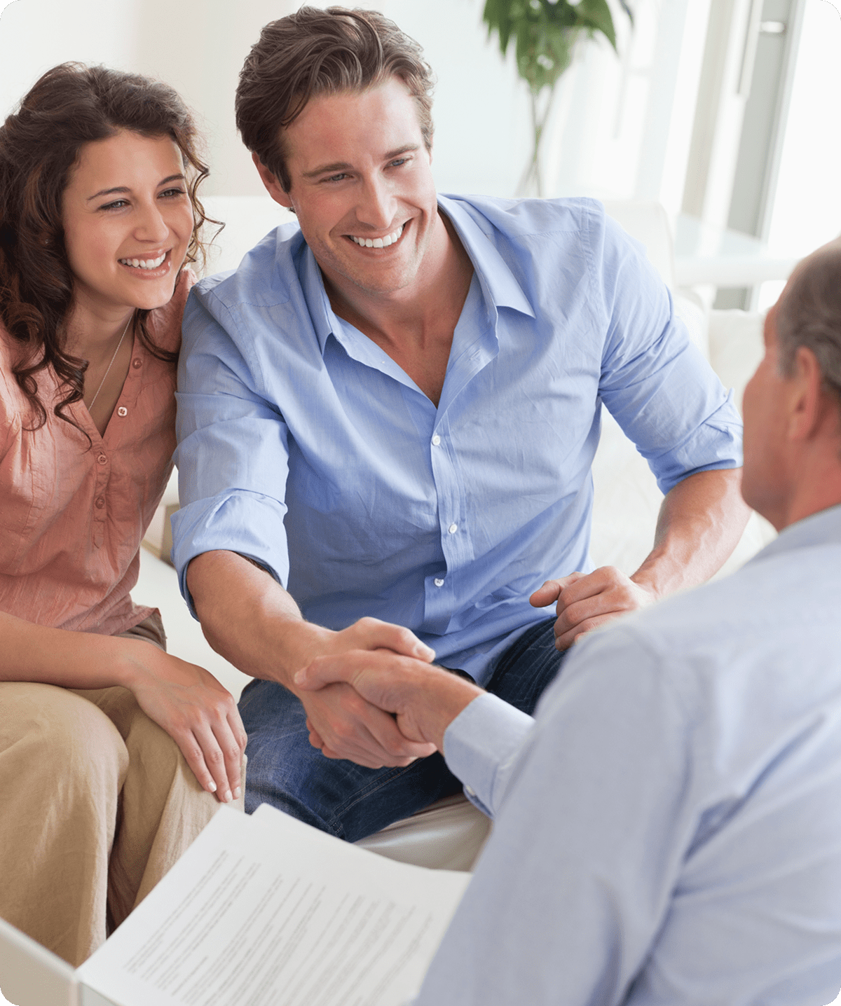 Couple meeting with professional, shaking hands.